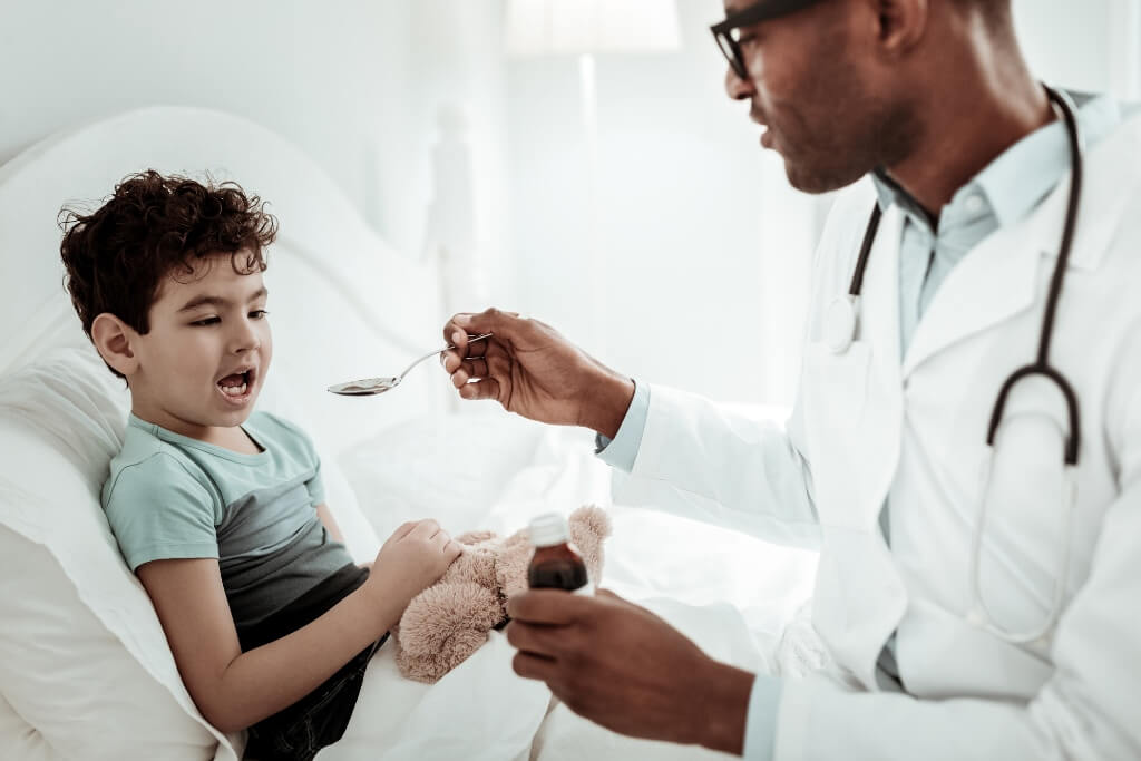 Doctor Giving Syrup To A Child